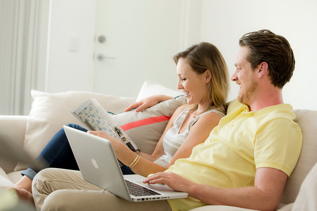 Couple on couch with laptop