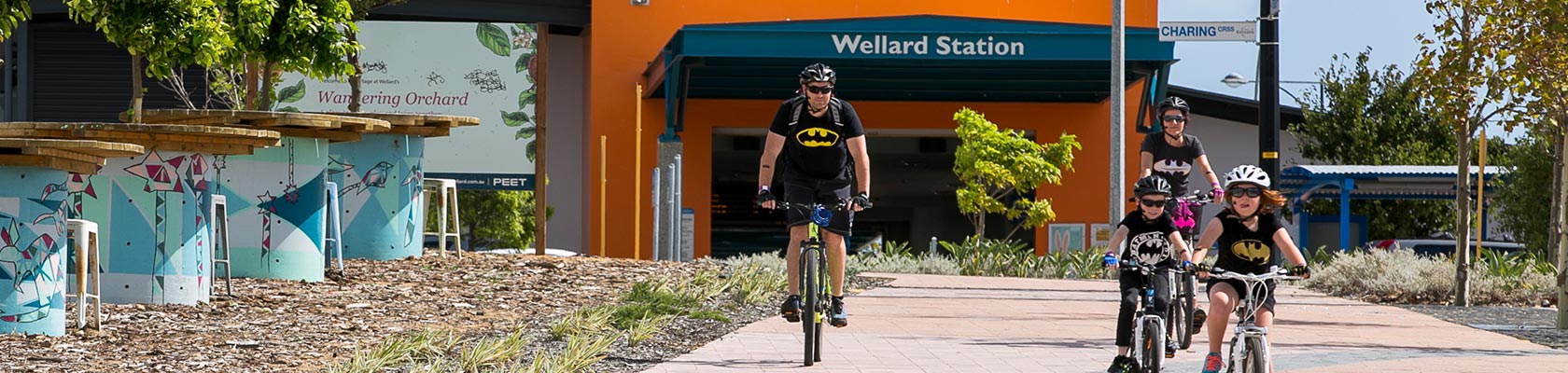 Family riding through The Village at Wellard