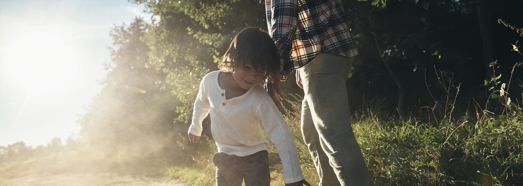 Boy walking on dirt road