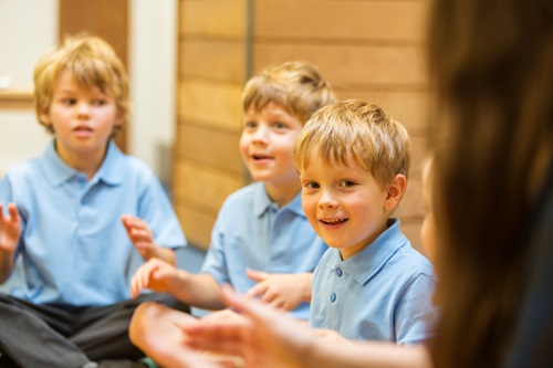 Children learning at school near Riverbank