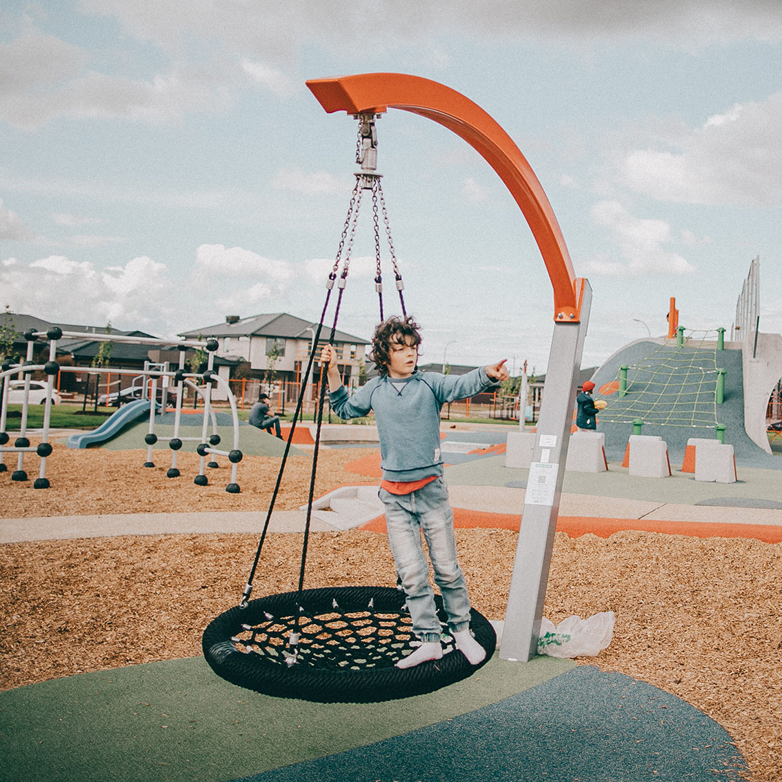 Universal Park Tarneit Boy Standing on round swing