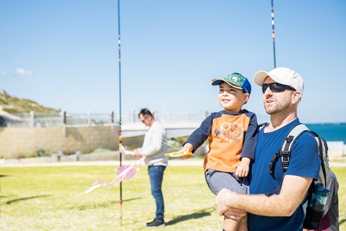 kite festival_dad helping son fly kite