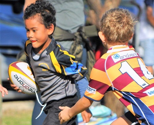 Two boys playing rugby for Swan Rugby Club