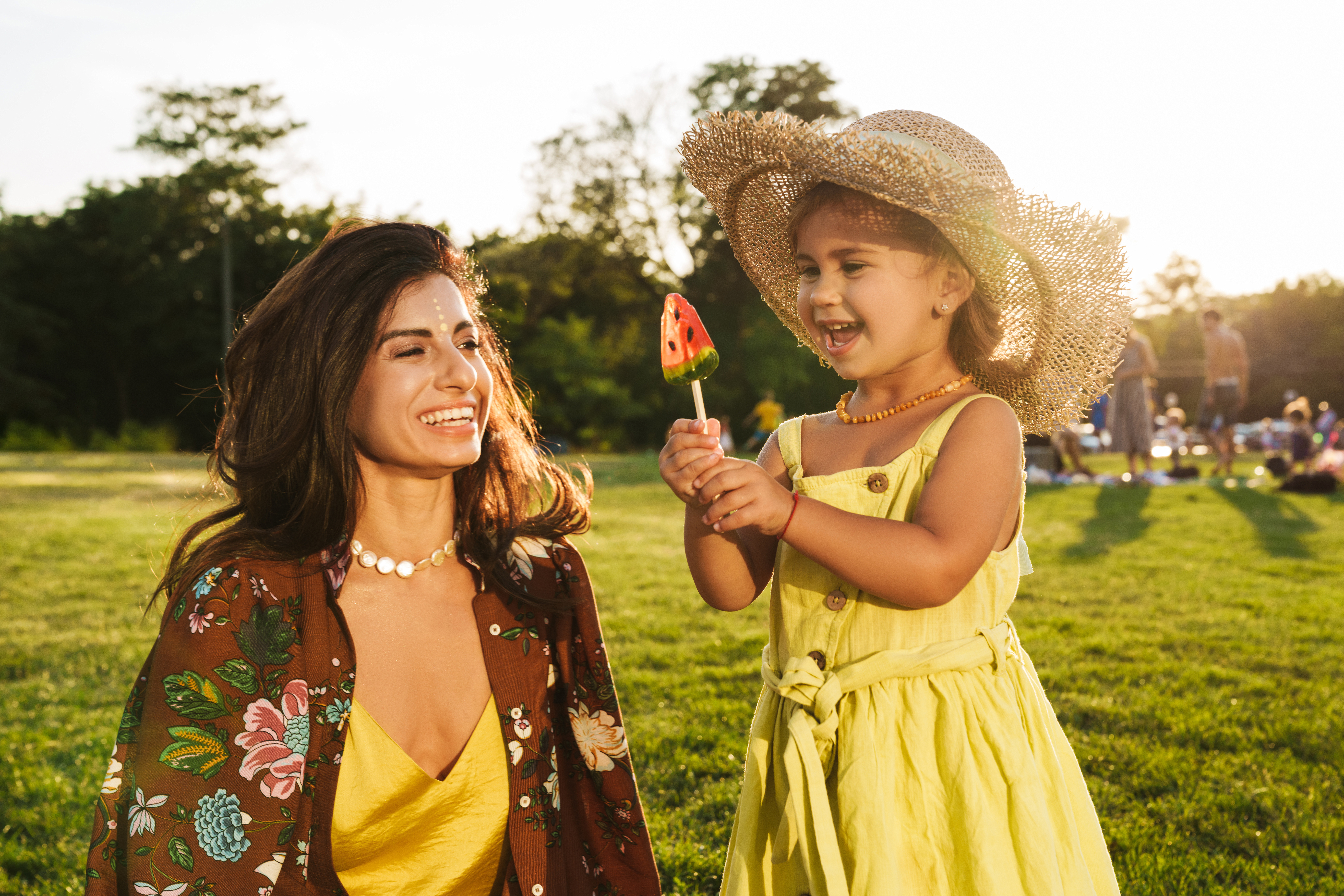 Mother having fun with her little daughter outdoors in nature green park.